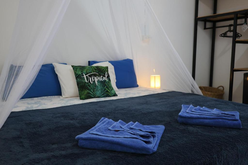 a bedroom with a bed with blue towels on it at Long beach simple House in Ko Lanta