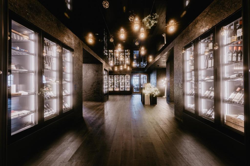 a hallway of a store with windows and a chandelier at Hotel Berghof - St Johann in Salzburg in Sankt Johann im Pongau