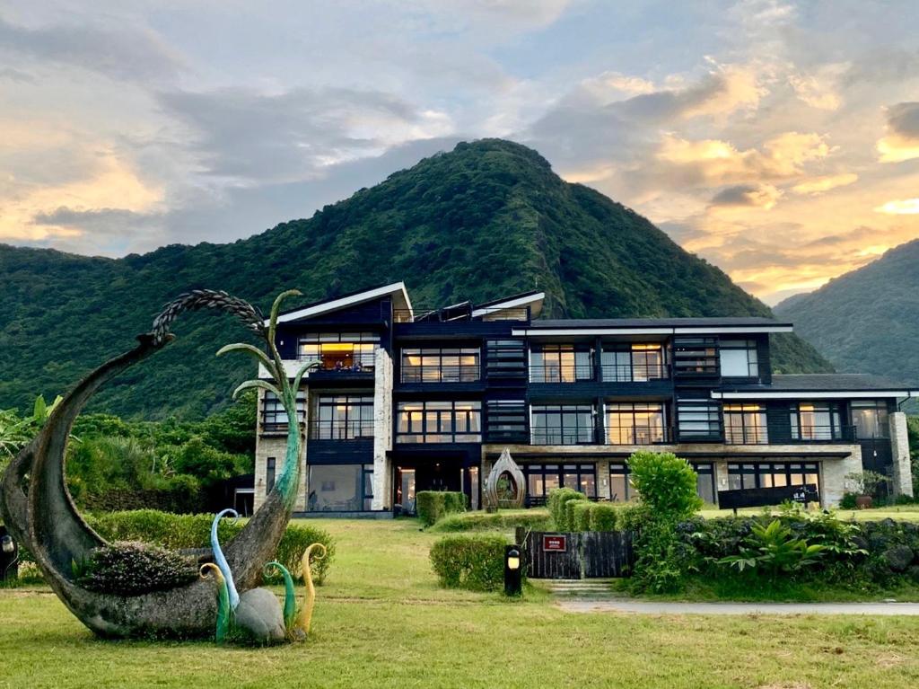 a large house with a statue in front of it at Adagio Shihtiping in Fengbin