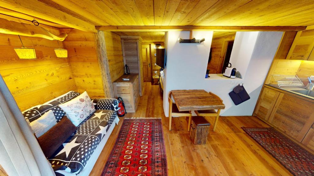 a room with a couch and a table in a room at Chesa Güglia Silvaplana in Silvaplana