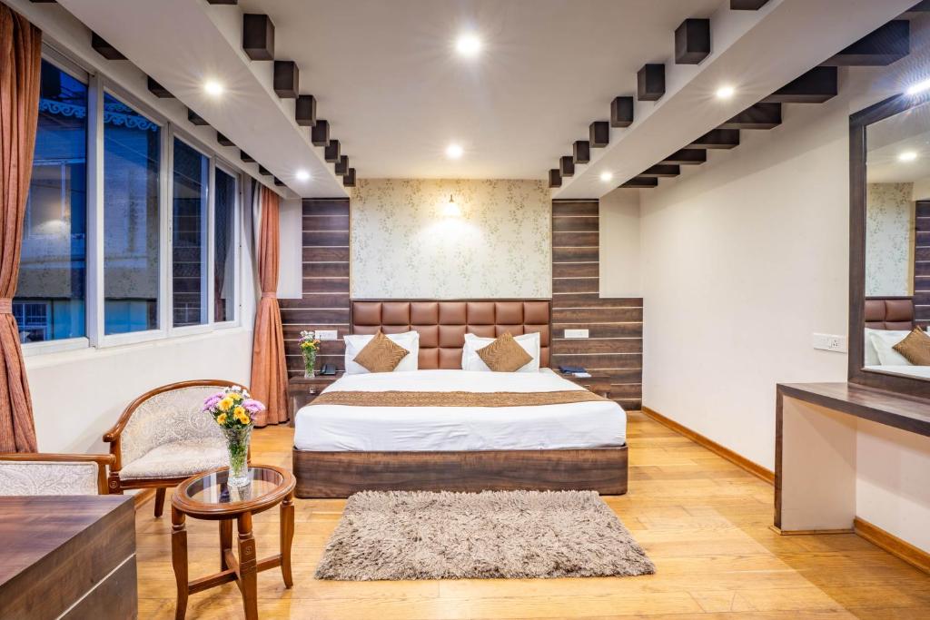 Postel nebo postele na pokoji v ubytování Jai Hotels