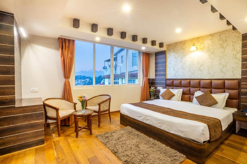 Postel nebo postele na pokoji v ubytování Jai Hotels