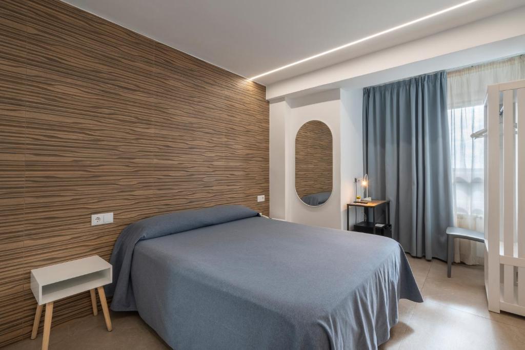 Postel nebo postele na pokoji v ubytování Hostal Pensimar