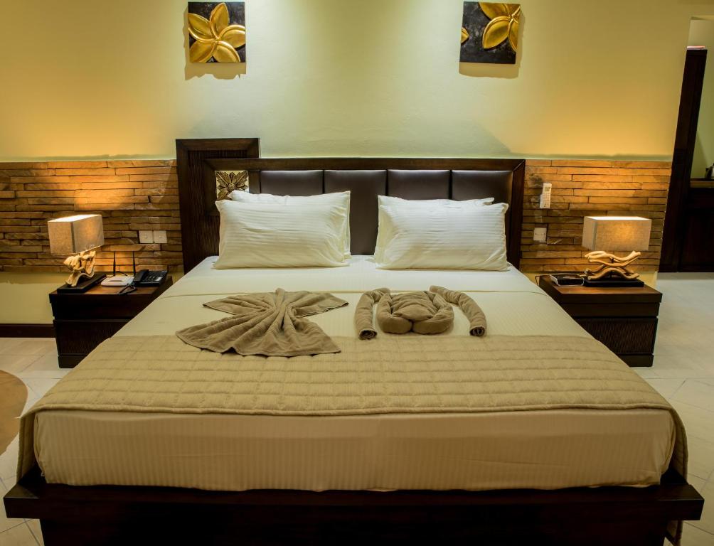 Кровать или кровати в номере Oasis Hotel Restaurant & Spa