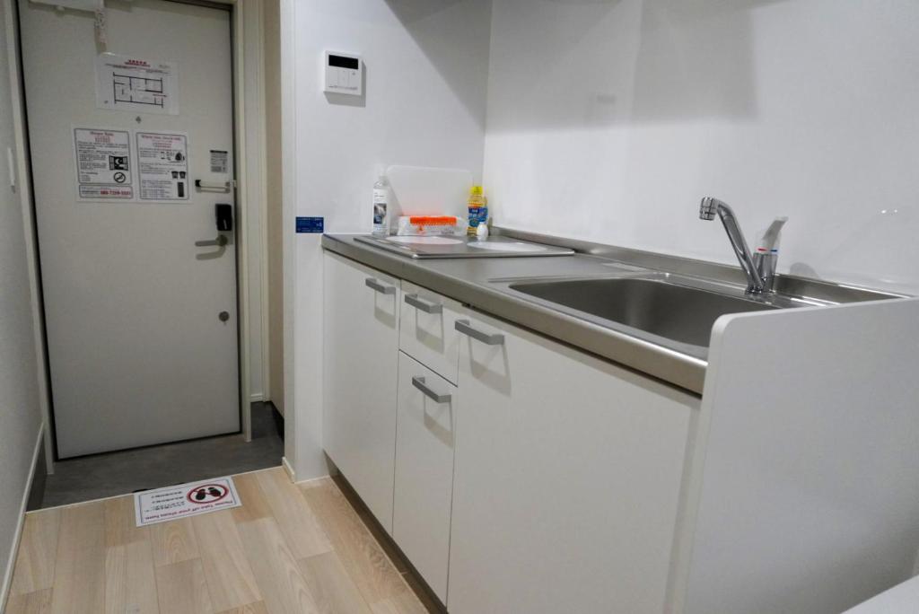 Kuchyň nebo kuchyňský kout v ubytování OUCHI HOTEL Onaganishi
