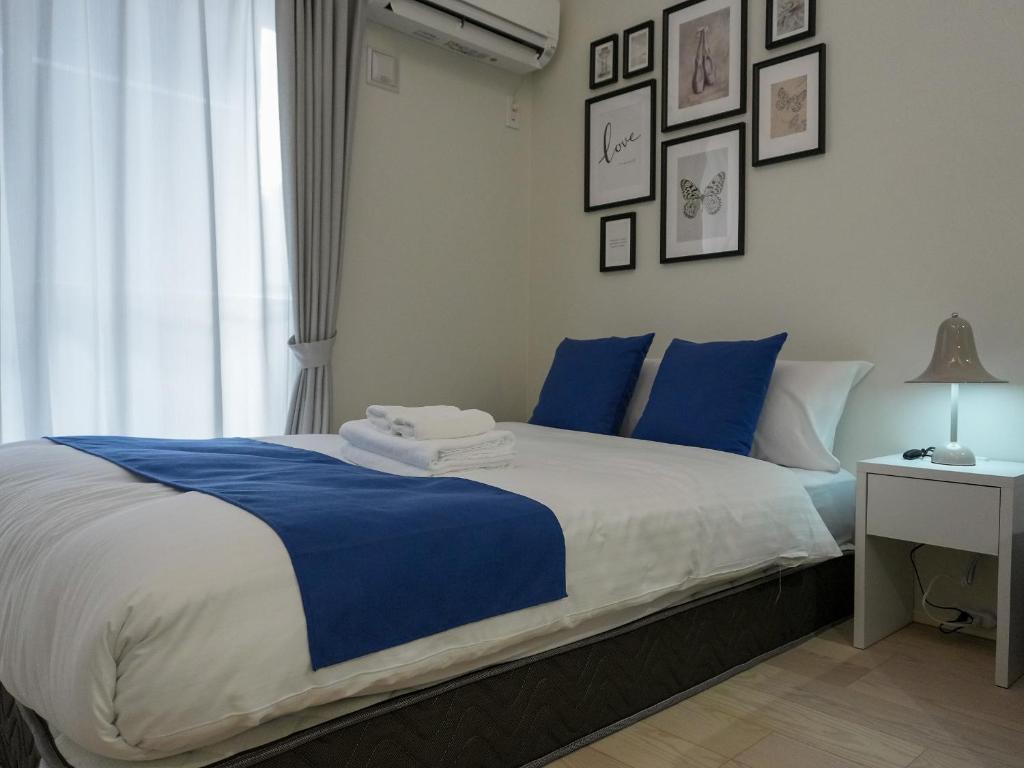 Postel nebo postele na pokoji v ubytování OUCHI HOTEL Onaganishi