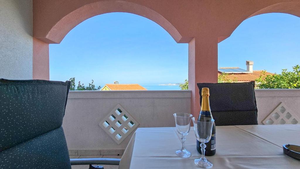 a bottle of champagne sitting on a table with two glasses at Stefi 1 in Crveni Vrh