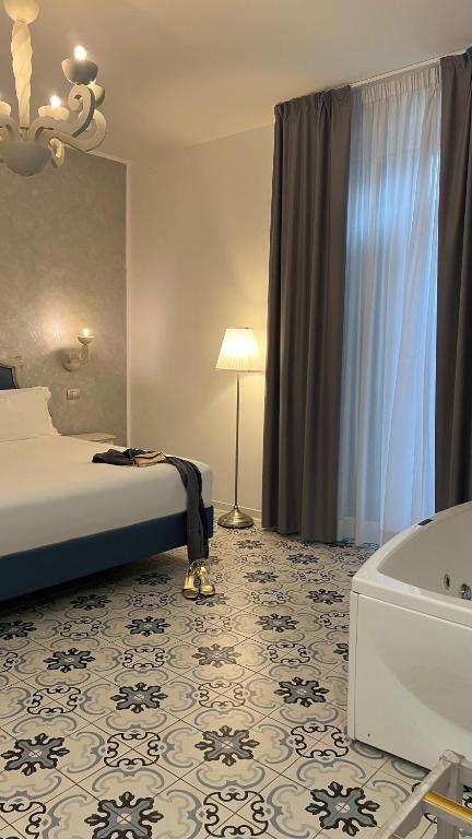 A bed or beds in a room at PLAZA Boutique Hotel - Tropea