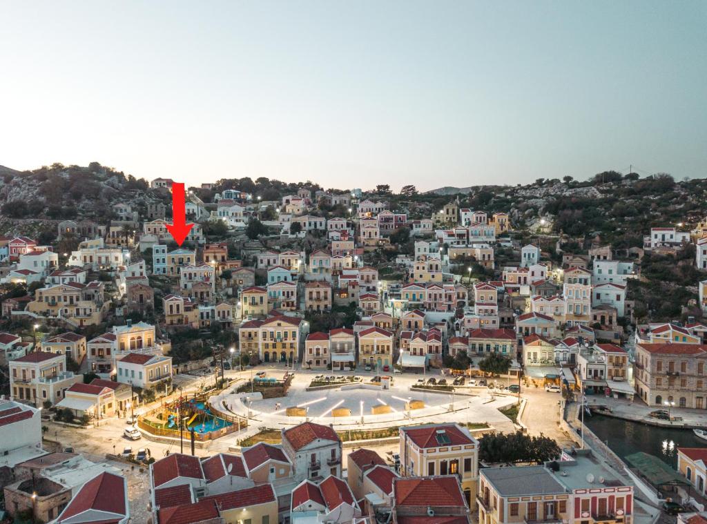 an aerial view of a city with a red arrow on it at Afaia Apartments in Symi