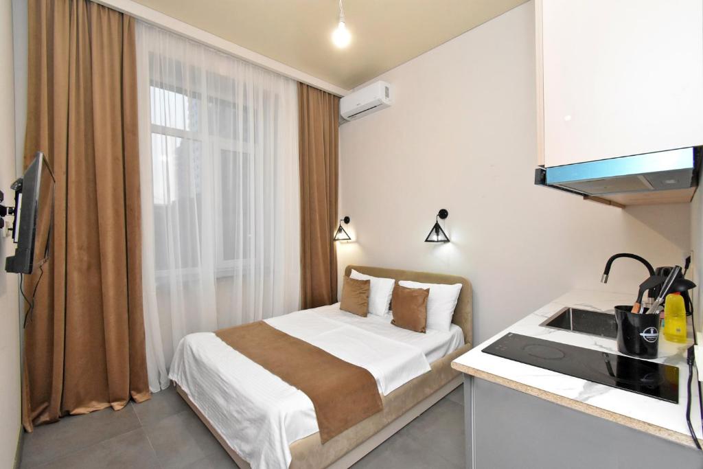 Postel nebo postele na pokoji v ubytování Seva Apart-Hotel Komitas