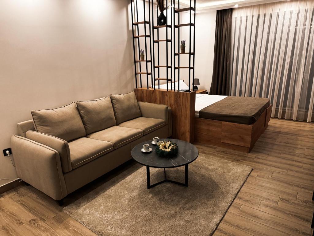 a living room with a couch and a table at Mokoš apartman, Residence hill A35, minimum dve noći in Kopaonik