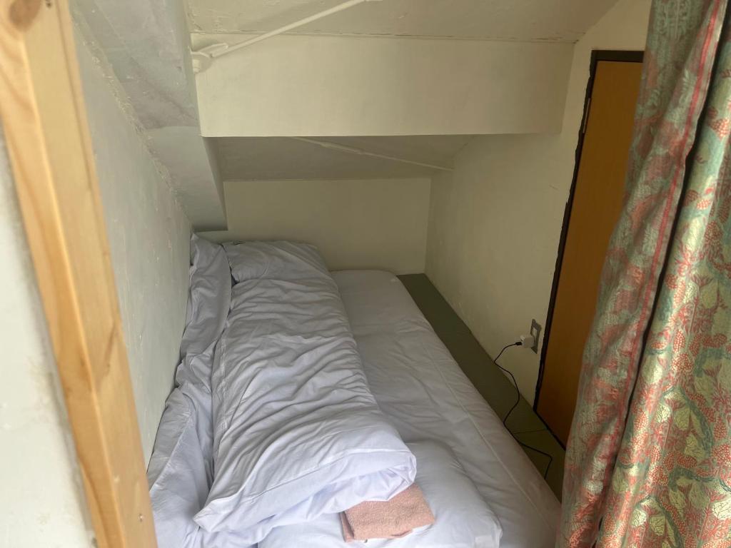 Postel nebo postele na pokoji v ubytování Guest House Ichiyama Shukuba