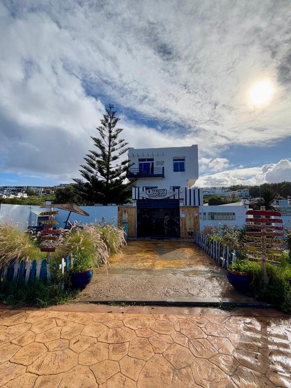 a white building with a fence in front of it at Surf house apartment in Oualidia
