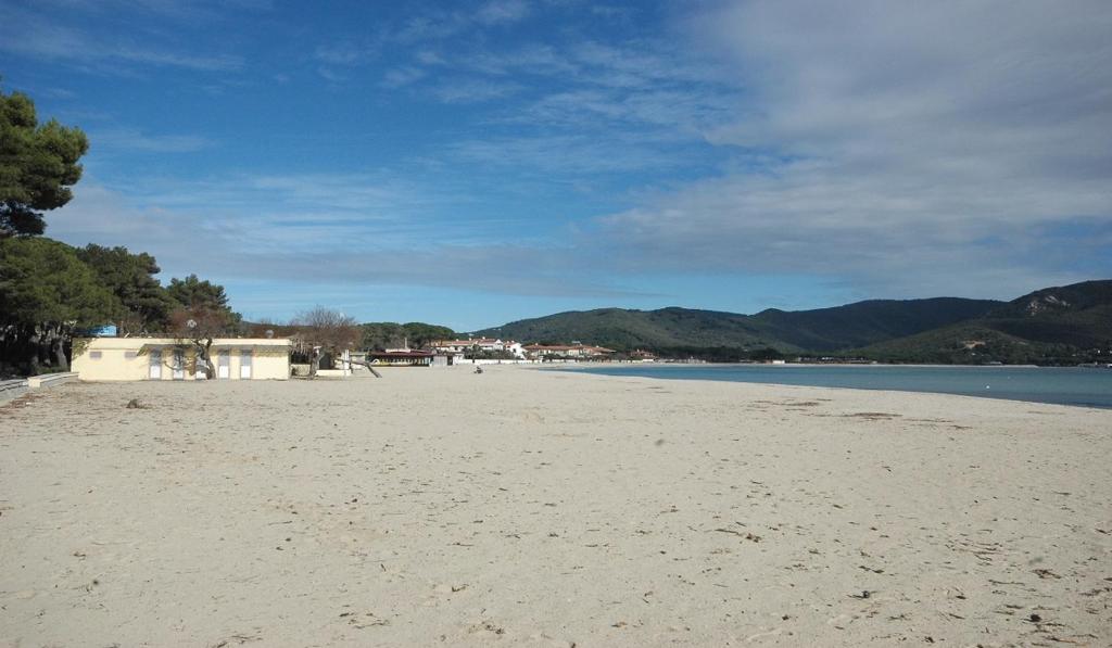 a view of a beach with mountains in the background at Gelsomino in Marina di Campo