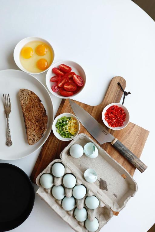 a table with eggs on a cutting board with a knife at Rezidence KUPEC in Frymburk