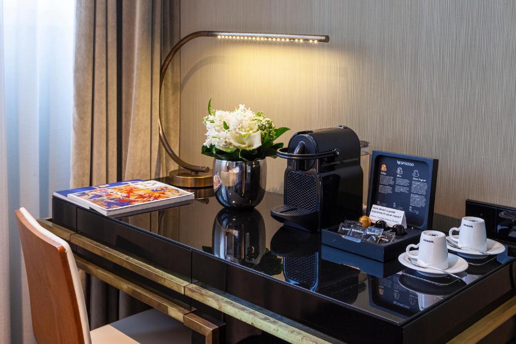 A polished in-room desk set up for coffee and light work.