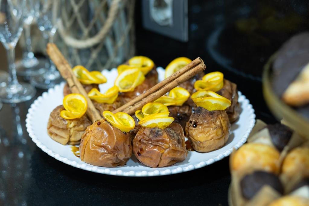 a plate of pastries with orange slices and cinnamon sticks at Hotel del Mar in Barcelona
