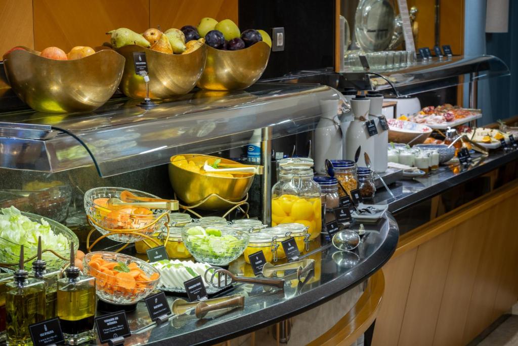 a buffet line with fruit and other food items at Hotel del Mar in Barcelona