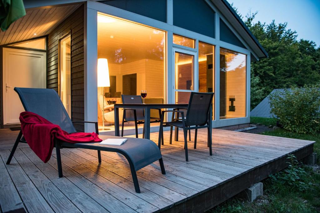 a patio with a table and chairs on a deck at 4 Personen mit Sauna F3H6 in Ruhla