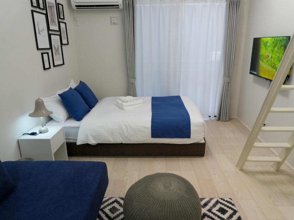 Postel nebo postele na pokoji v ubytování OUCHI HOTEL Onaganishi