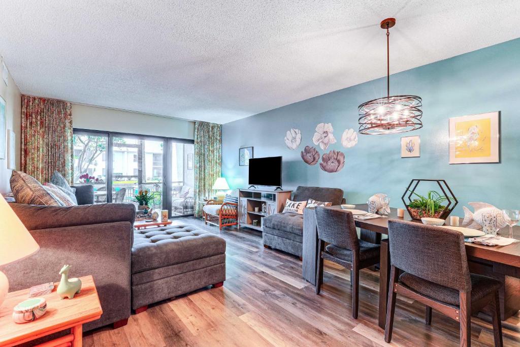 a living room with a couch and a table at Condo with Patio and Resort Amenities in Fort Pierce! in Fort Pierce