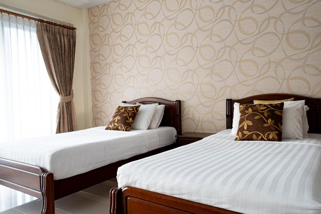 Postel nebo postele na pokoji v ubytování Alisa Krabi Hotel-SHA Plus