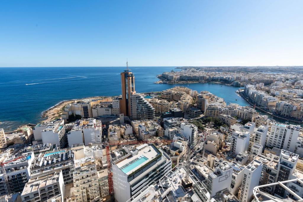 an aerial view of a city and the ocean at Oasis on the 27th, Mercury Tower in St Julian's