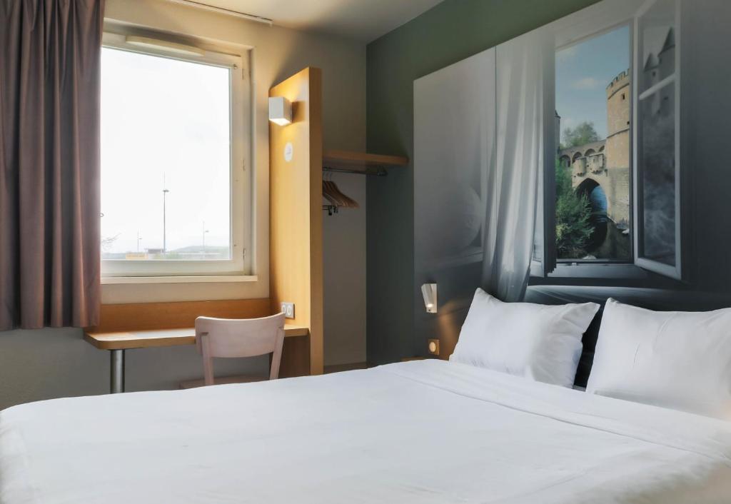 Postel nebo postele na pokoji v ubytování B&B HOTEL Metz Semécourt