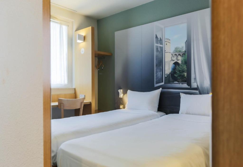 Postel nebo postele na pokoji v ubytování B&B HOTEL Metz Semécourt