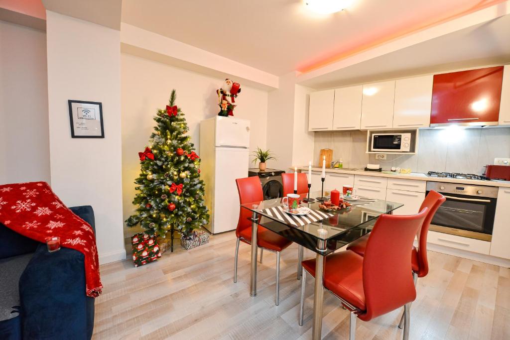 a kitchen with a table and a christmas tree at CityScape Bucharest in Bucharest