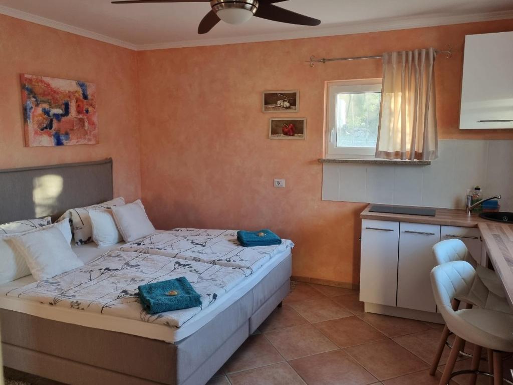 a bedroom with a bed with two blue bags on it at Casa Maichen Olbia in San Pantaleo