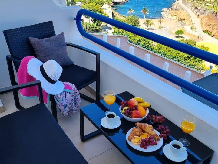 a table with a bowl of fruit on a balcony at Dream Ocean Sunset in Playa Paraiso
