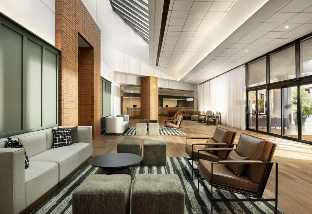 a lobby with a couch and chairs and a table at Sonesta Los Angeles Airport LAX in Los Angeles