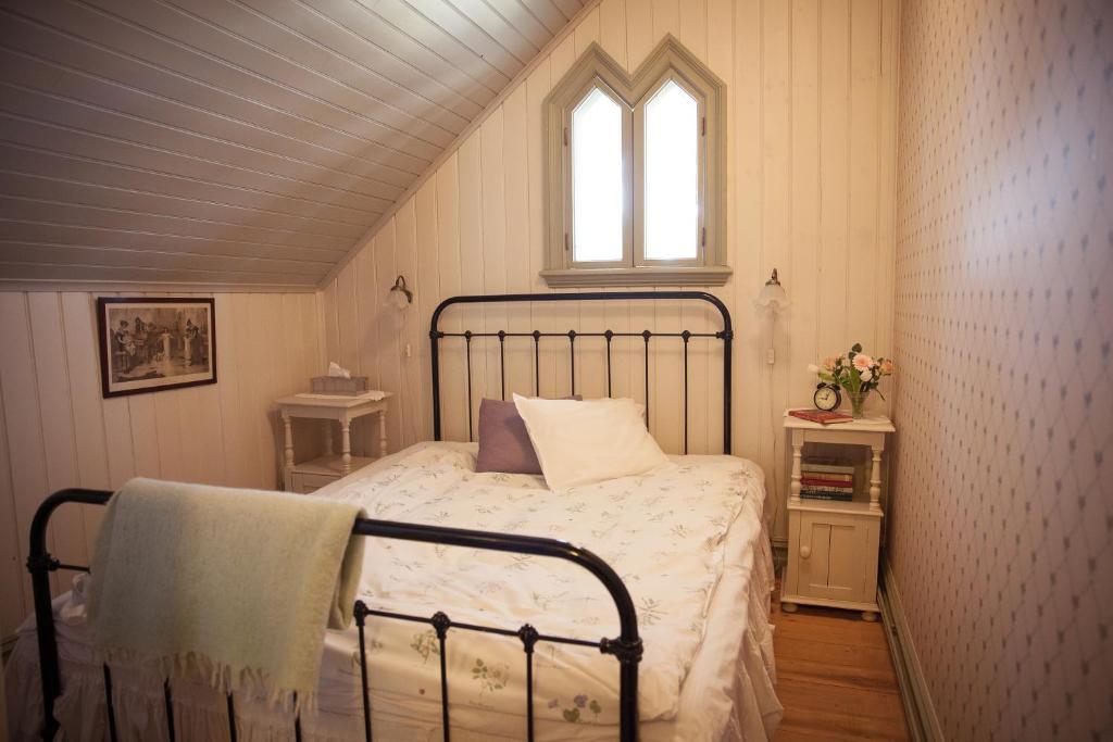 a bedroom with a bed and a window in a attic at Villa Sjötorp in Ljungskile