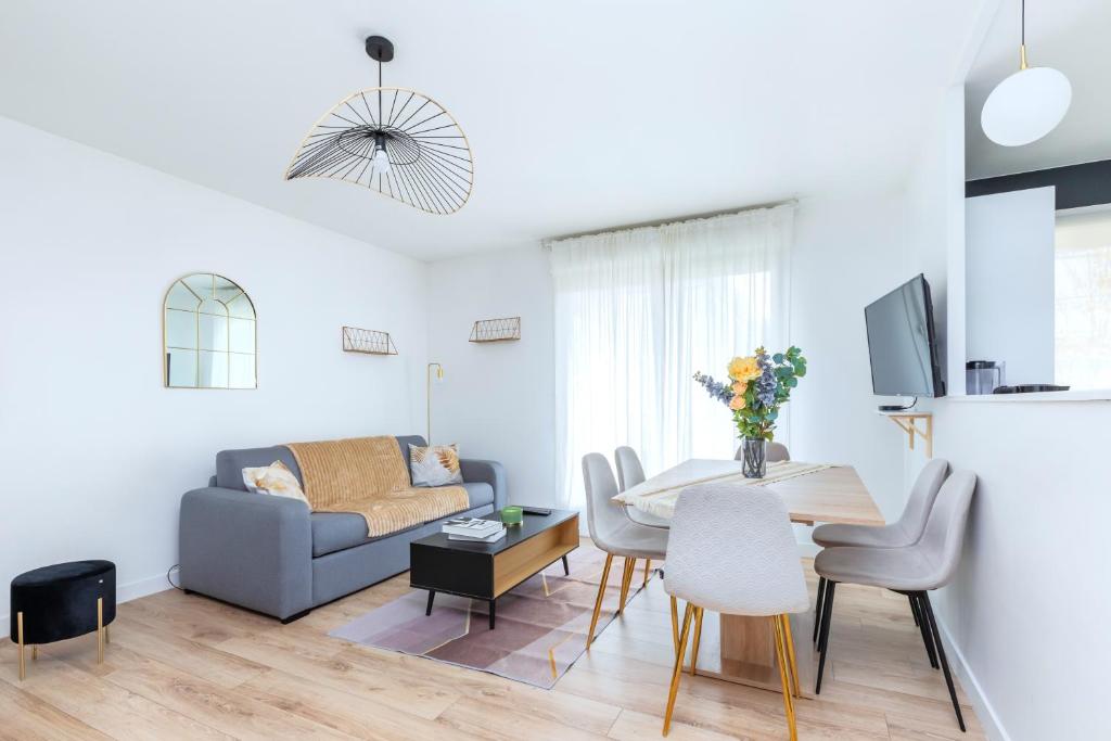 un salon avec une table et un canapé dans l'établissement Lovely appartement au Stade de France, à Saint-Denis