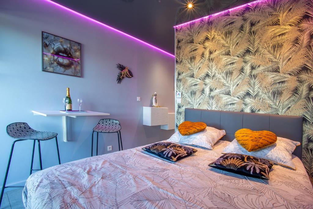 une chambre avec un grand lit avec des oreillers orange dans l'établissement love secret port nature 7, au Cap d'Agde