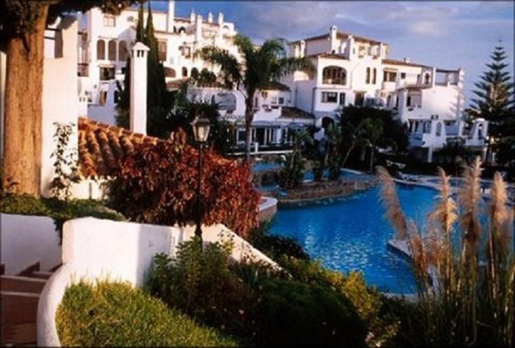 a view of a house and a swimming pool at BBQ Evita Beach Club in Benalmádena