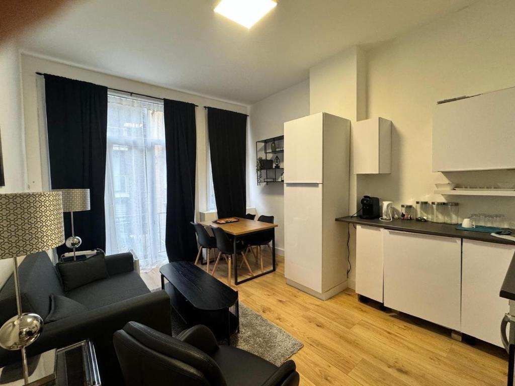 salon z kanapą i stołem oraz kuchnią w obiekcie 2 bedroom apartment 1 floor in Blankenberge Vrijheidstraat 3 w mieście Blankenberge