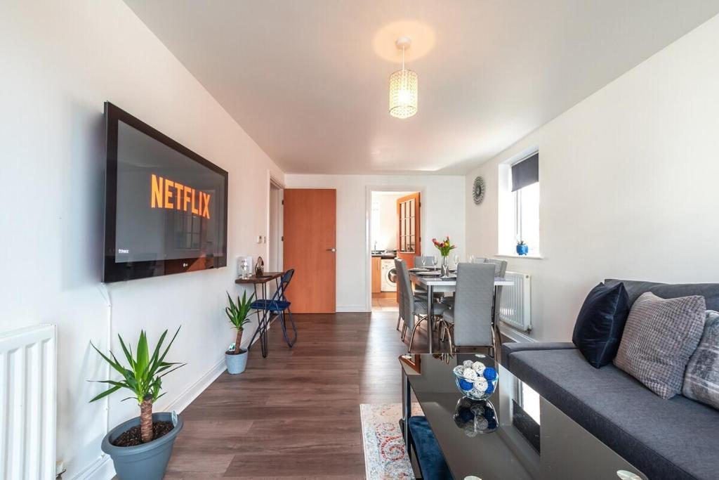 a living room with a couch and a table at Apartment in Ashford near outlets and Ashford International Station in Willesborough