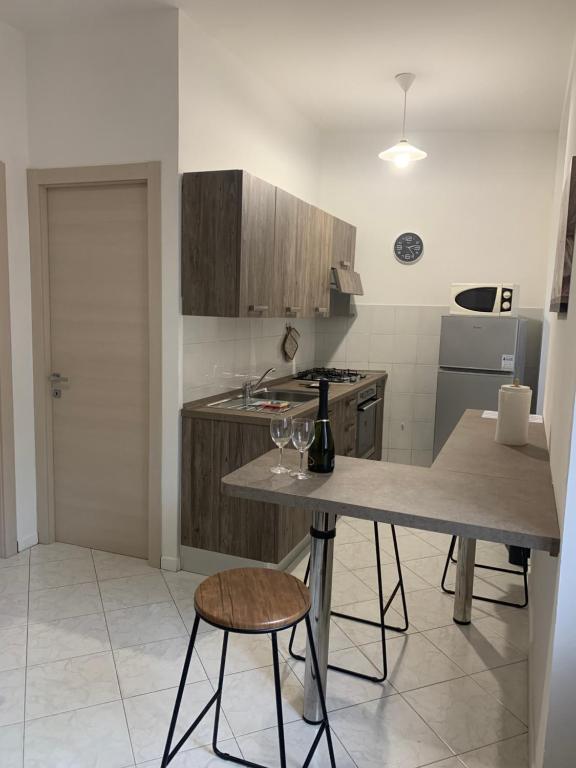 a kitchen with a table with two wine glasses on it at Zar in Omegna