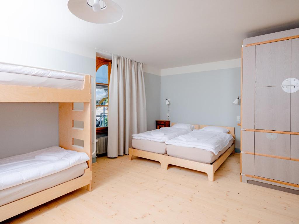 Voodi või voodid majutusasutuse Grand Hotel du Cervin - Auberge de jeunesse et spa toas
