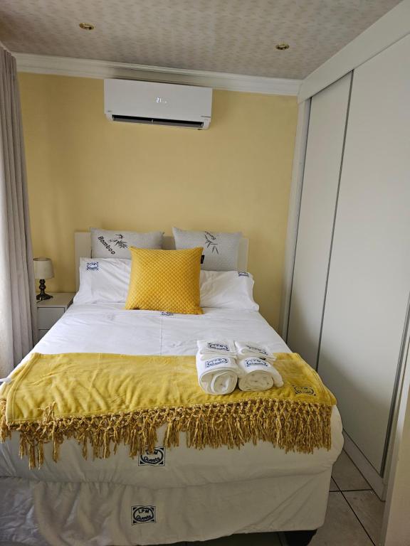 a bedroom with a bed with two towels on it at LPM Guests at 21st in Pretoria