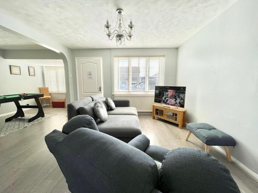 a living room with a couch and a tv at Haven lovely home just off M20 in great area & parking in Kent