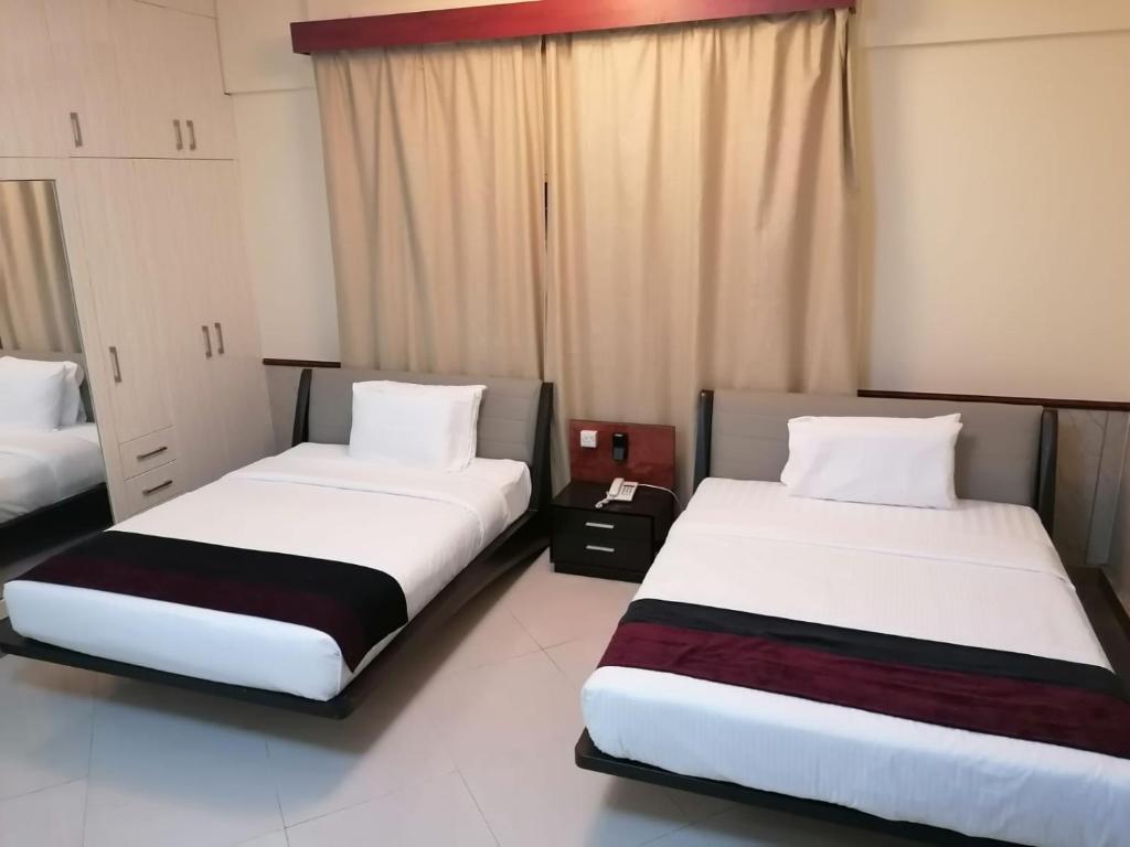 Postel nebo postele na pokoji v ubytování Claridge Star Hotel