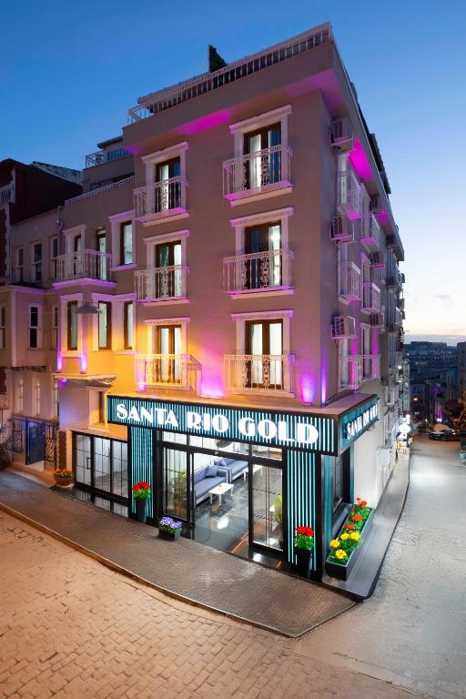 a pink building with purple lights on a street at Santa Rio Gold Taxim Hotel in Istanbul