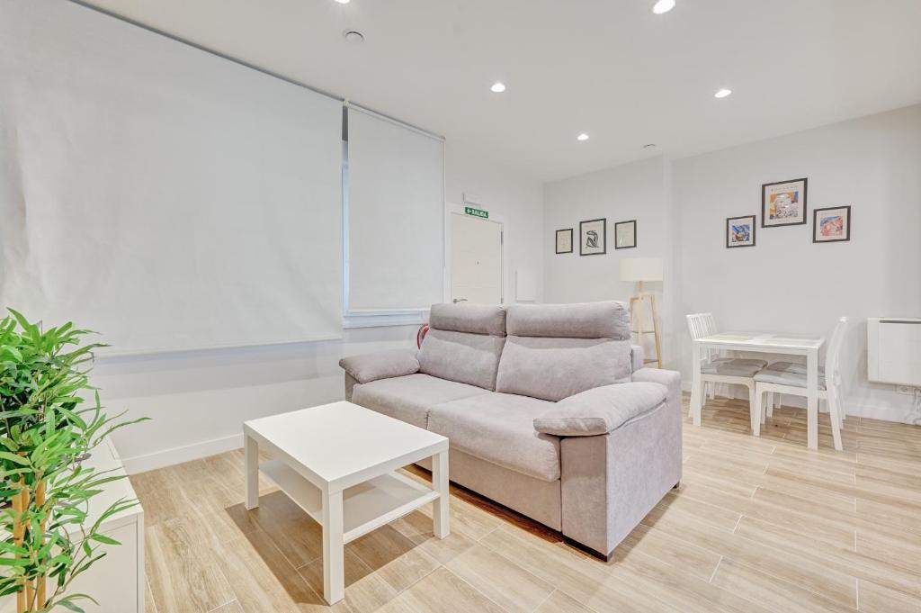 a living room with a couch and a table at Premin By Clabao in Pamplona