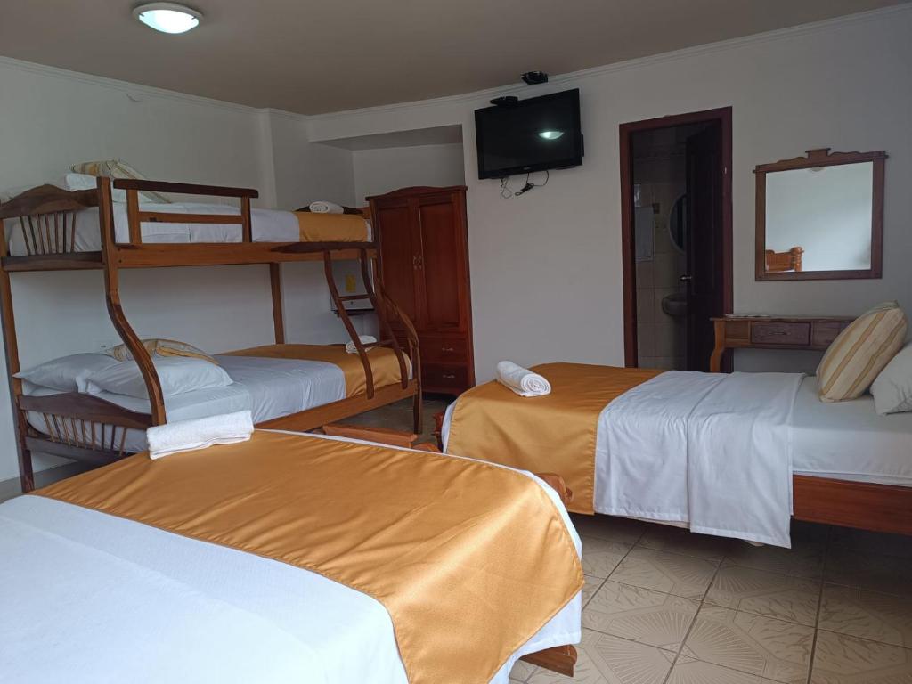 Postel nebo postele na pokoji v ubytování Hostal Bicentenario