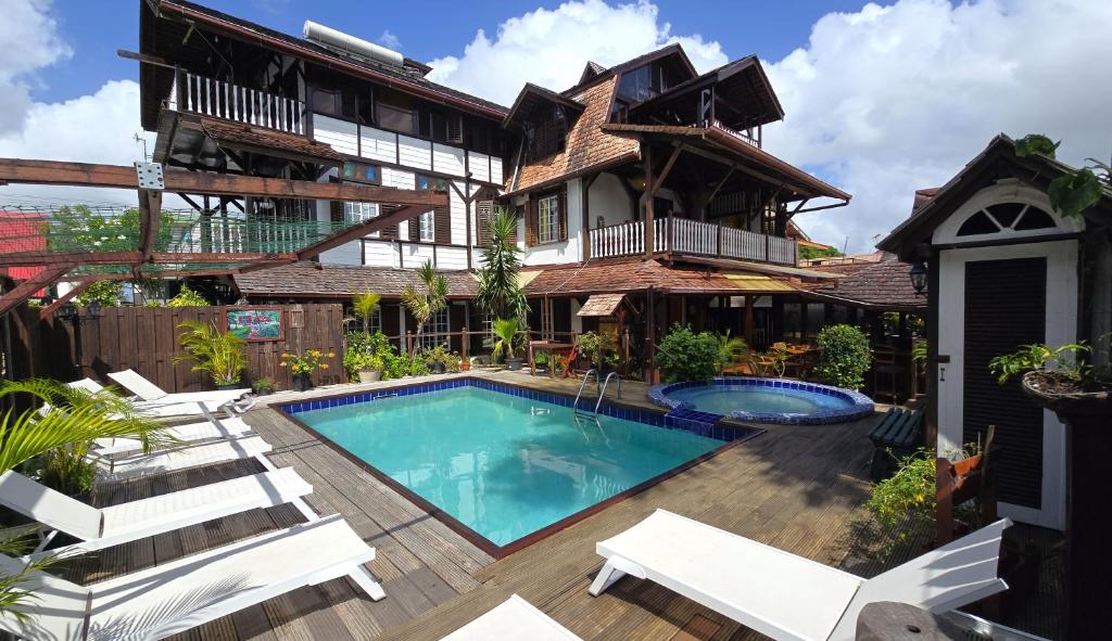 an image of a house with a swimming pool at Greenheart Boutique Hotel in Paramaribo