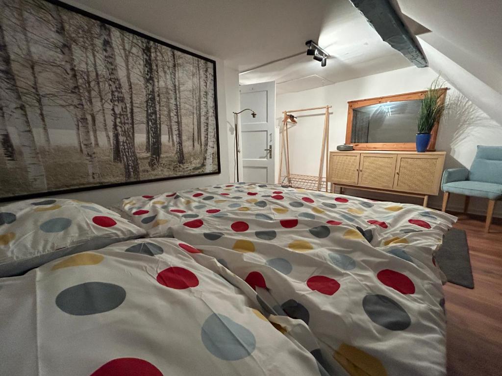 a bedroom with a large bed with polka dot sheets at Altes Dichterhaus von 1859 in Miltenberg