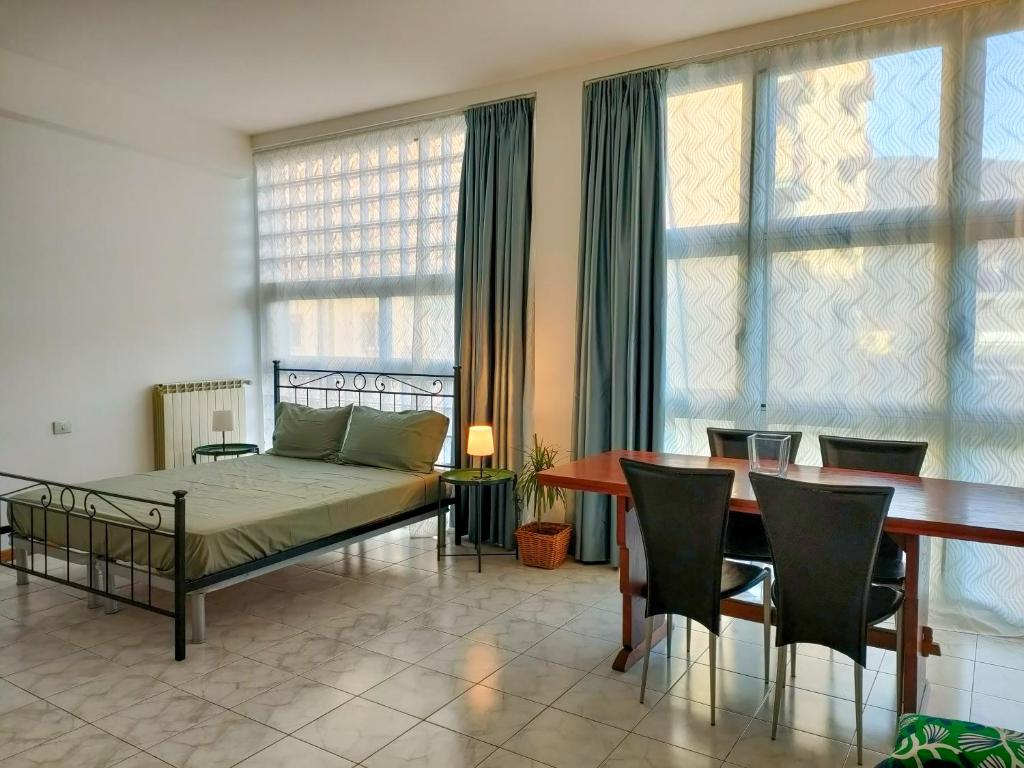 ein Wohnzimmer mit einem Bett und einem Tisch und Stühlen in der Unterkunft Palestro Studio - A Cozy Apartment in Como in Como